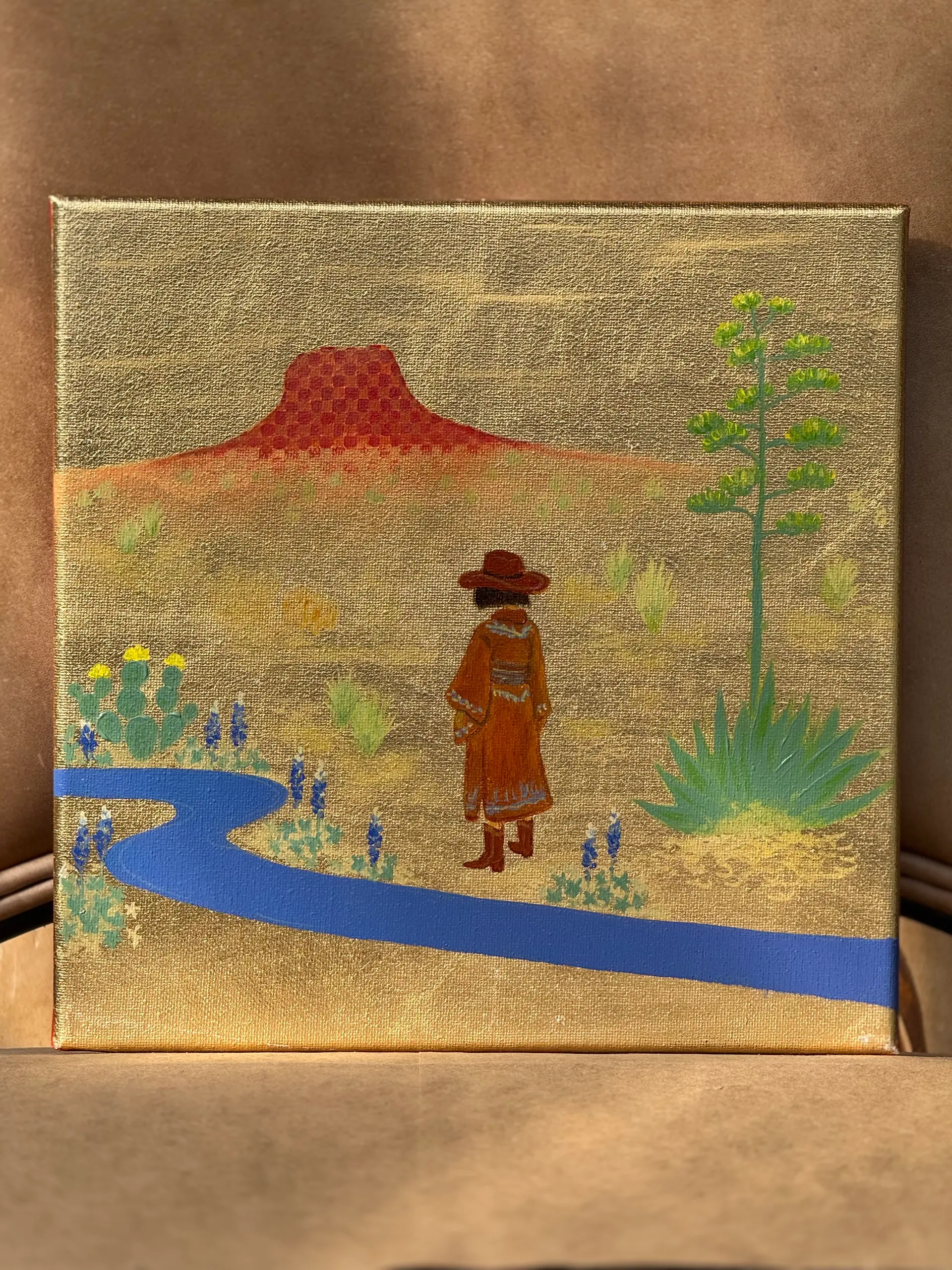 A red mesa and blue river in a colorful West Texas desert landscape.