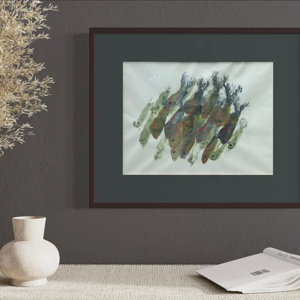 A framed watercolor of fish formed from layered blue, green, and gold marks.