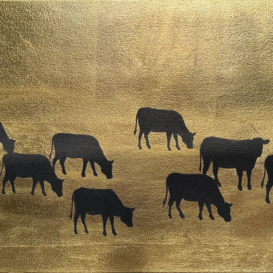 Dark cow silhouettes scattered across a reflective gold field.