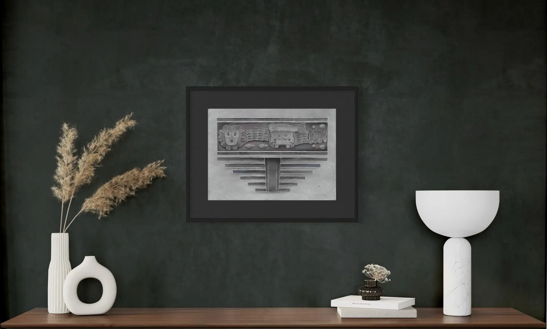 A framed grayscale drawing of carved faces above stepped architectural forms.